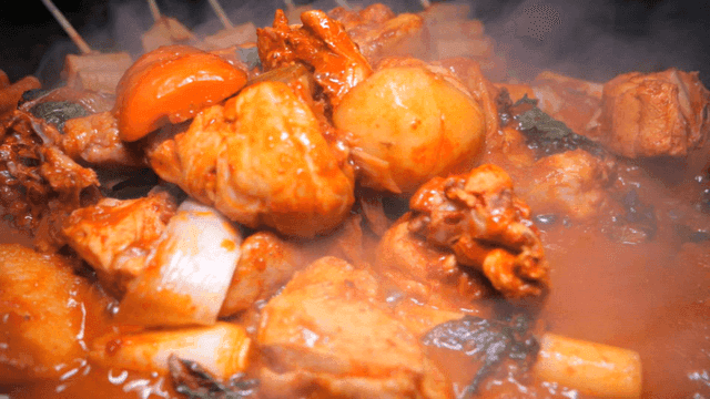 Chicken stew boiling in rich broth