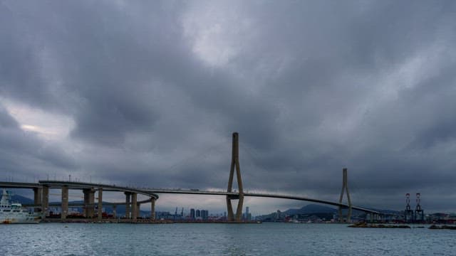 Change in the sky with gloomy clouds over the Busan Port Bridge and the sea