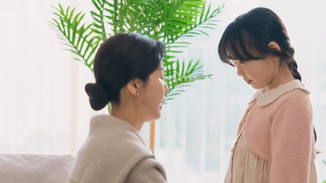 Mother braiding her daughter's hair