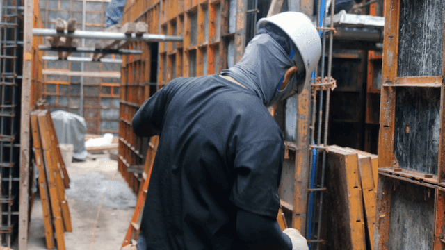 Construction worker assembling metal frames