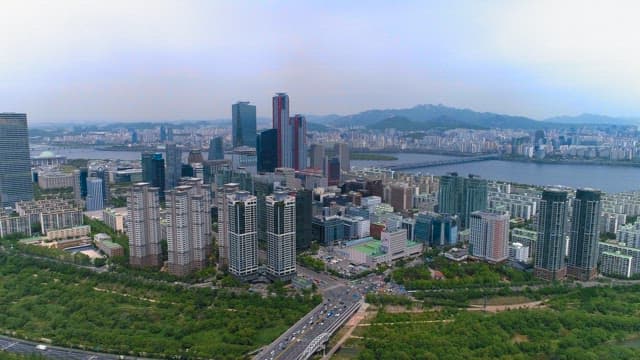 Bustling Cityscape by River