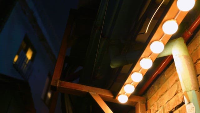 Dimly lit alley with glowing bulbs