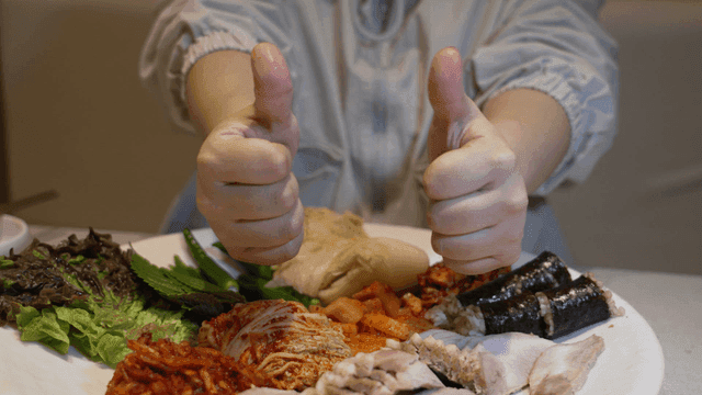 Person enjoying a Korean meal indoors