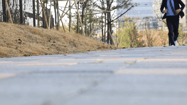 A person running quickly along a park trail