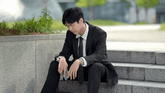 Office worker sitting on stairs in despair