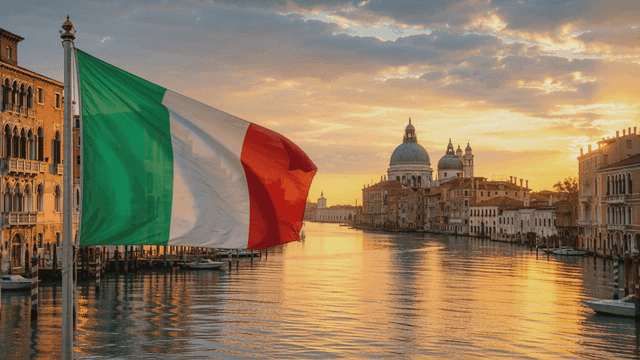 Italian flag waving by a canal at sunset
