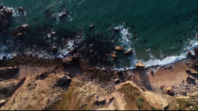 Aerial View of Coastal Cliffs and Waves