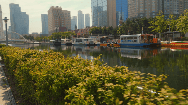 Modern cityscape with canal and boats