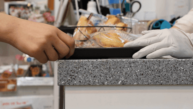 Bakery items being handled on a counter