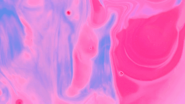 Abstract pattern of purple and pink liquids mixing together