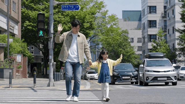Father and daughter crossing crosswalk