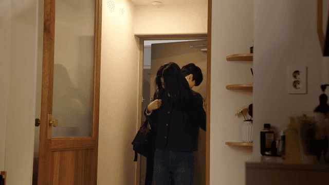 Warm couple entering apartment entrance