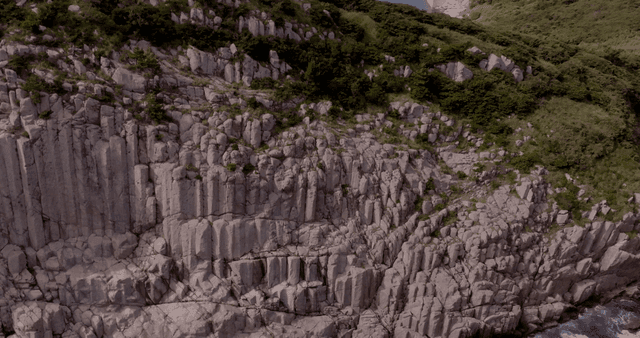 Rocky cliffs by the ocean with waves