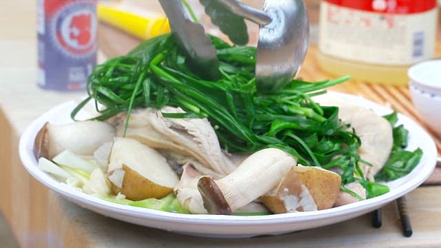 Plate of boiled vegetables and mushrooms on a table