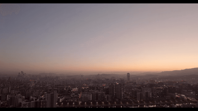 City skyline at dusk with a fading sunset