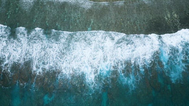 Aerial View of Crashing Waves on Coastline