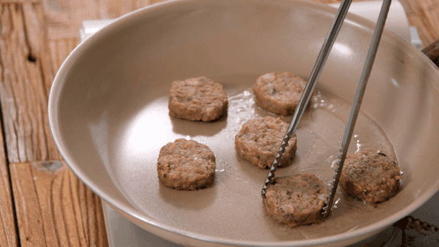 Patties frying in a pan with oil