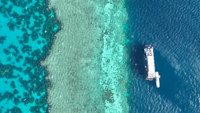 Boat Floating on Clear Blue Sea