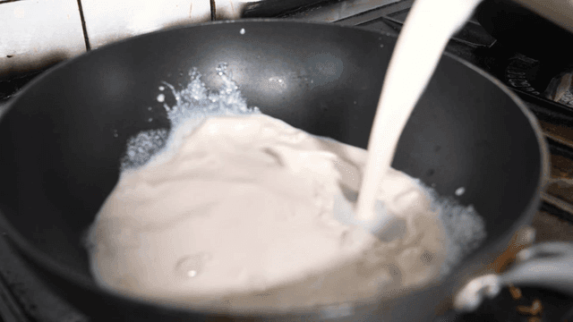 Cream sauce poured into frying pan