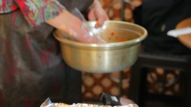 Cow skin salad on foil on a grill at a meat restaurant