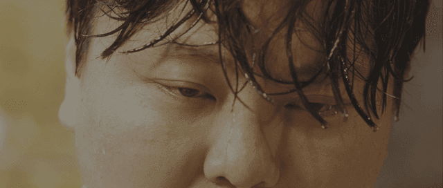 Person with wet hair and water droplets