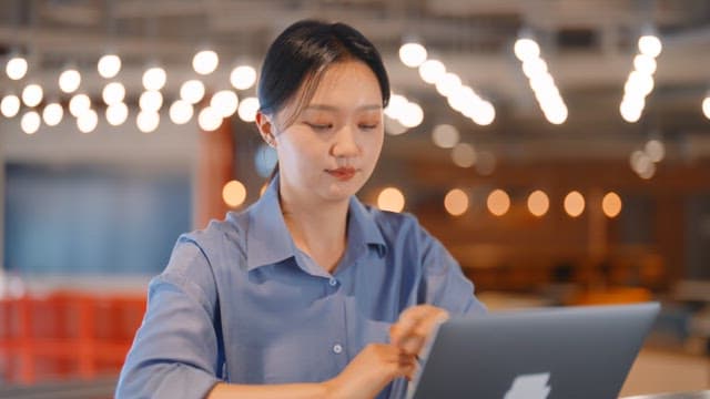 Woman working on a laptop in a modern office