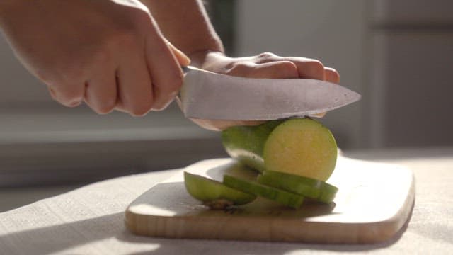 Slicing a Squash on a Cutting Board