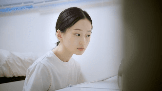 Woman concentrating on mirror at her vanity