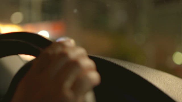 Evening Drive Against City Lights at Night