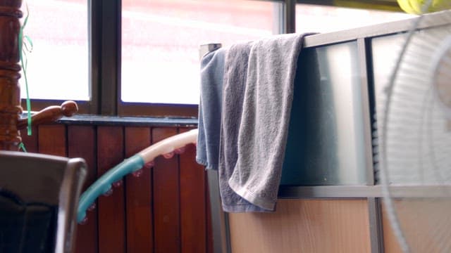 Towels hanging indoors near a window