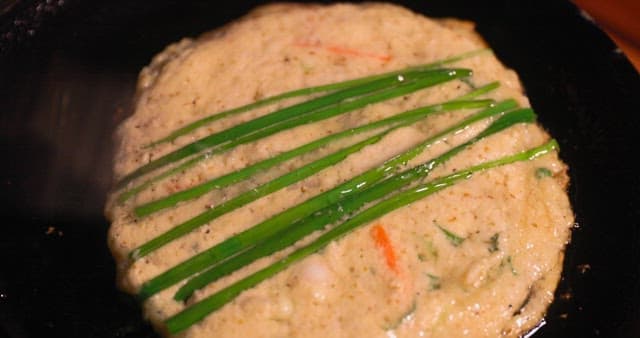 Preparing Savory Korean pancake on a Hot Skillet