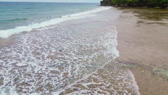 Waves gently lapping on a sandy beach