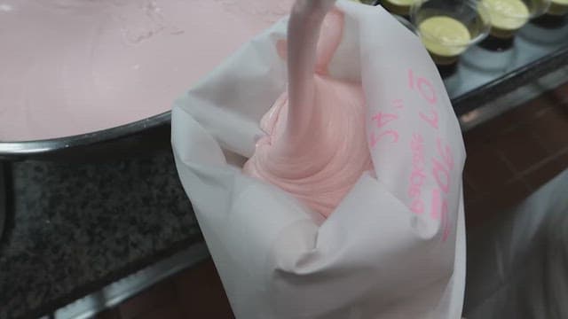 Pouring creamy bread batter into a piping bag