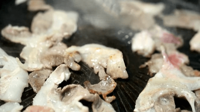 Grilling Grilled Pork Belly slices on a hot pan