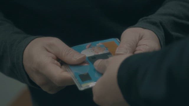 Person Holding a Bankbook and Card of Bank