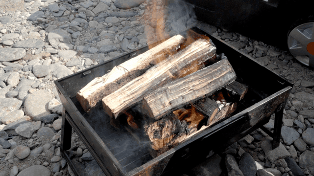 Firewood burning on gravel