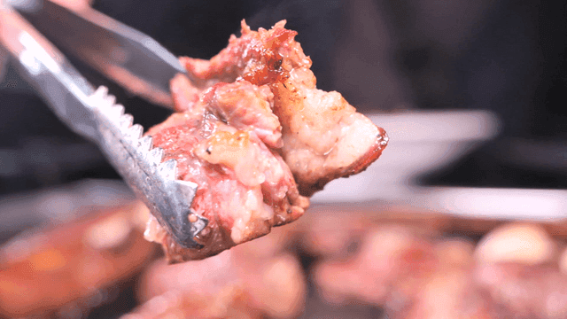 Beef grilled with tongs