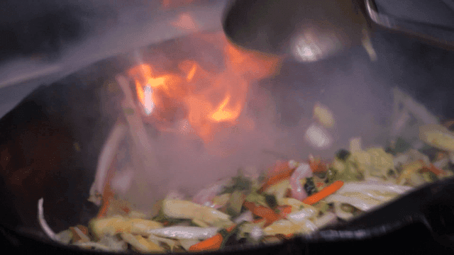 Vegetables stir-fried in hot wok