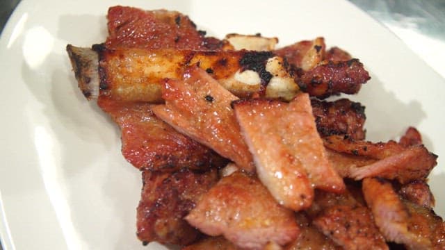 Grilled marinated pork ribs on a white plate