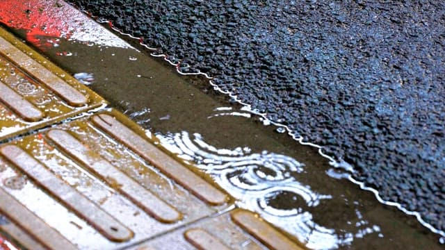 Raindrops falling on the floor with braille blocks