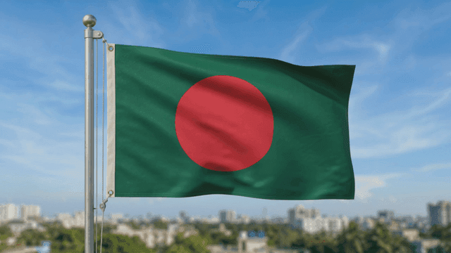 Bangladeshi flag fluttering against clear sky