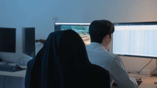 Man working late on a computer in the office