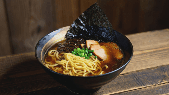 Bowl of ramen placed on wooden table
