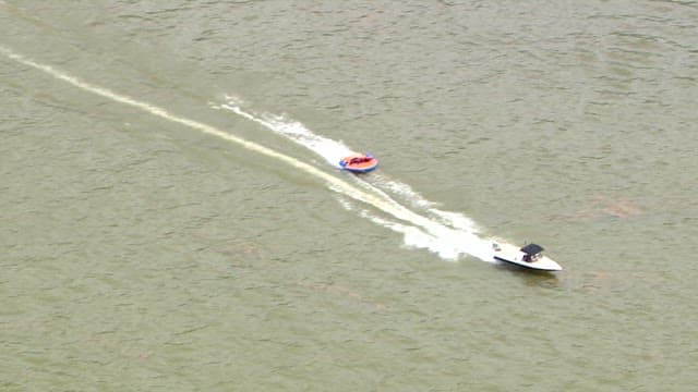 Bouncing Boat Hanging from a Motorboat