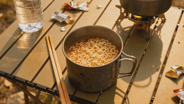 Camping mess tin ramen cooked on portable stove