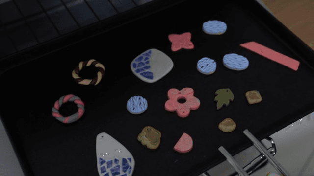 Colorful clay crafts on a baking tray