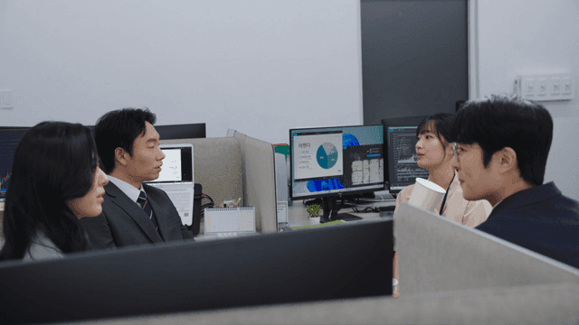 Office workers discussing at their desks