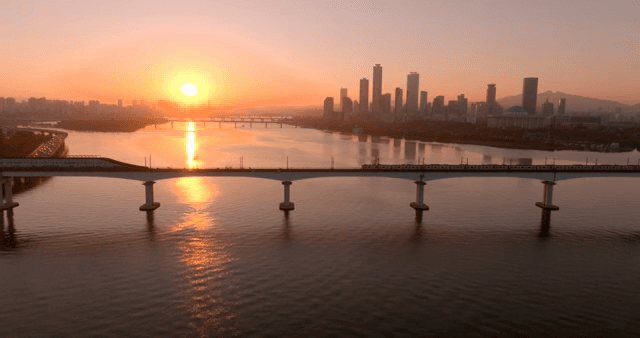 Sunset over a city skyline and river