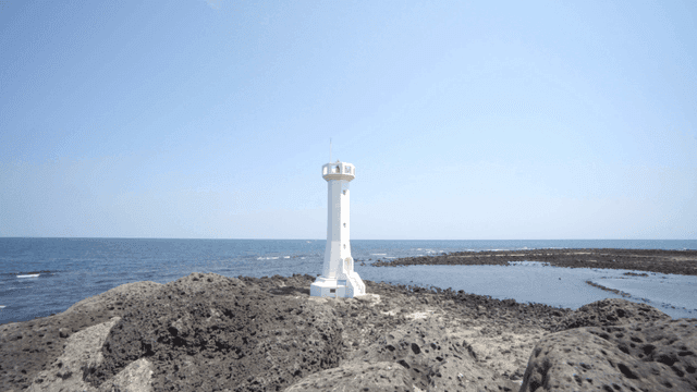 A lighthouse by the rocky seaside