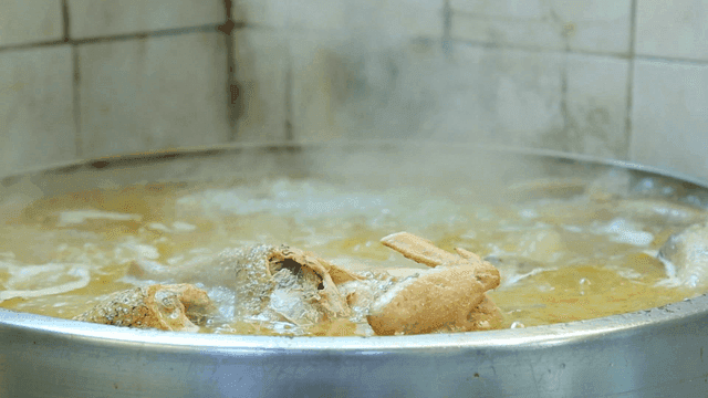 Chicken boiling in a large pot